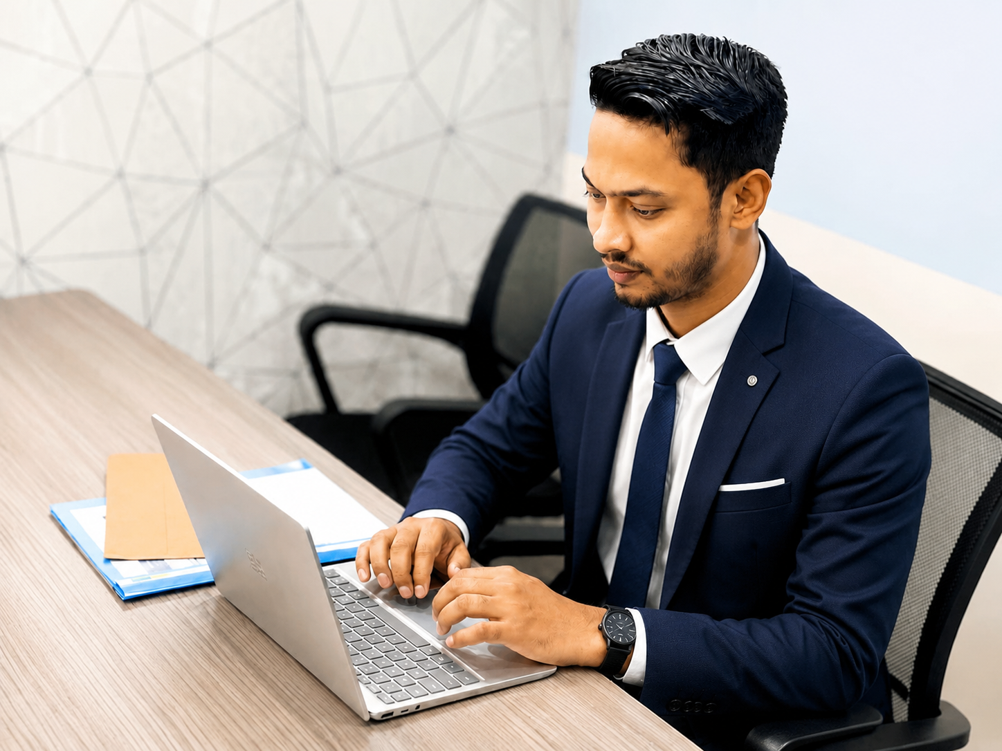 Md Naeem Hossan working at his desk in London office