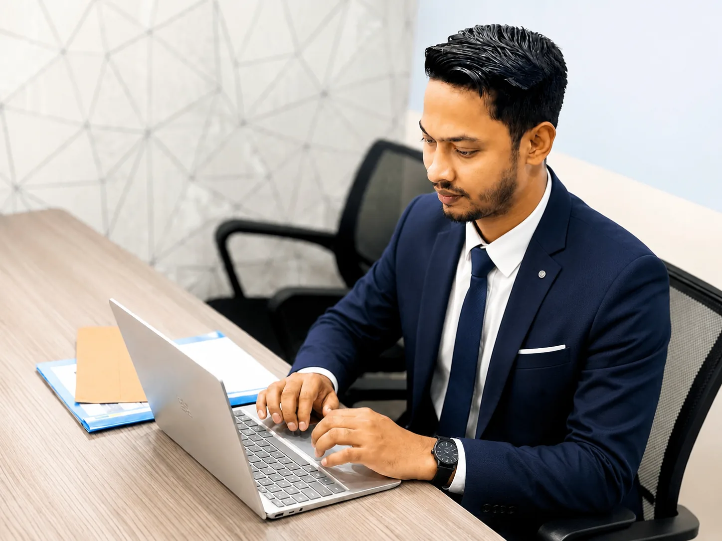 Md Naeem Hossan working at his desk in London office